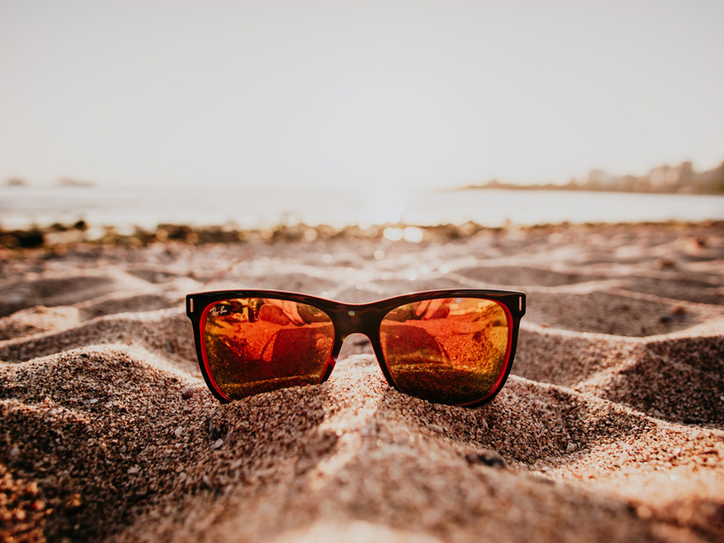 Mirror sunglasses in the sand