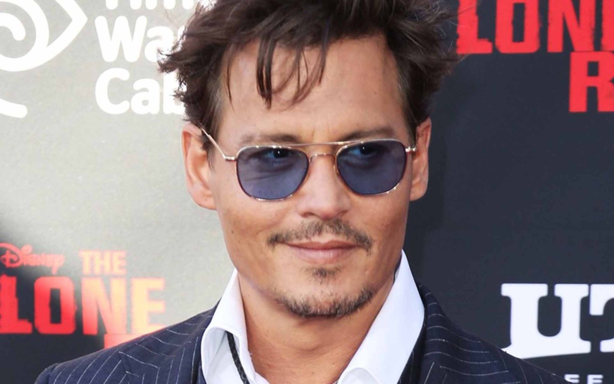 Johnny Depp showing off blue sunglass lenses while promoting The Lone Ranger!